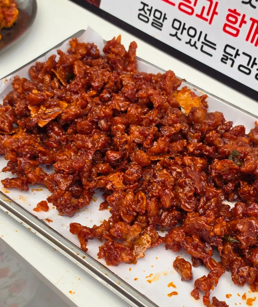 Original dakgangjeong topped with nurungji chips and black garlic