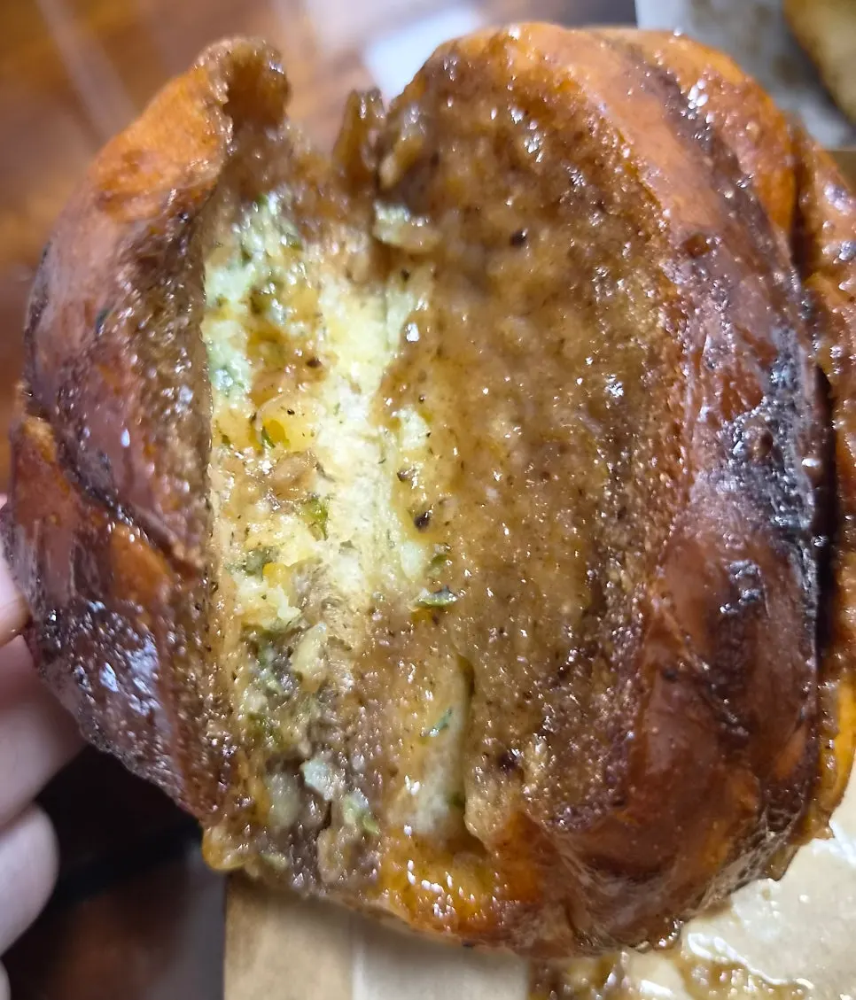 Black garlic salt bread with sauce soaked into the surface
