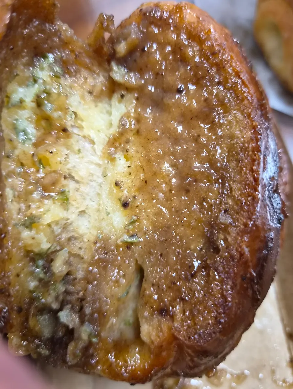 Cross-section of the black garlic salt bread with a bite taken out