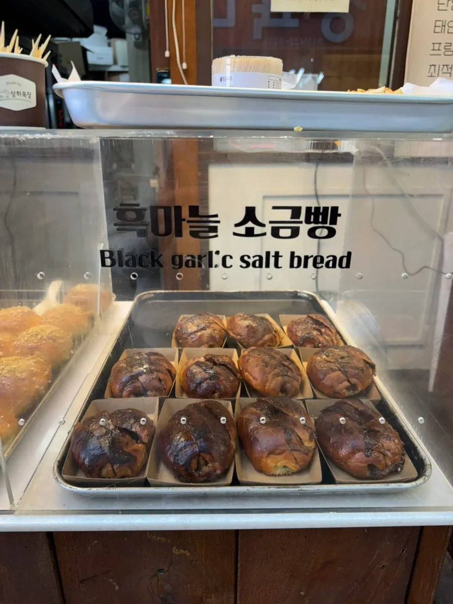 Golden-brown salt bread lined up on the display shelf