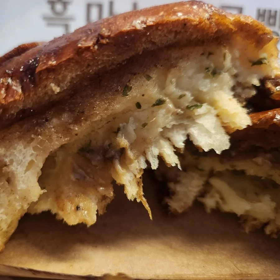 Cross-section of black garlic salt bread showing rich sauce