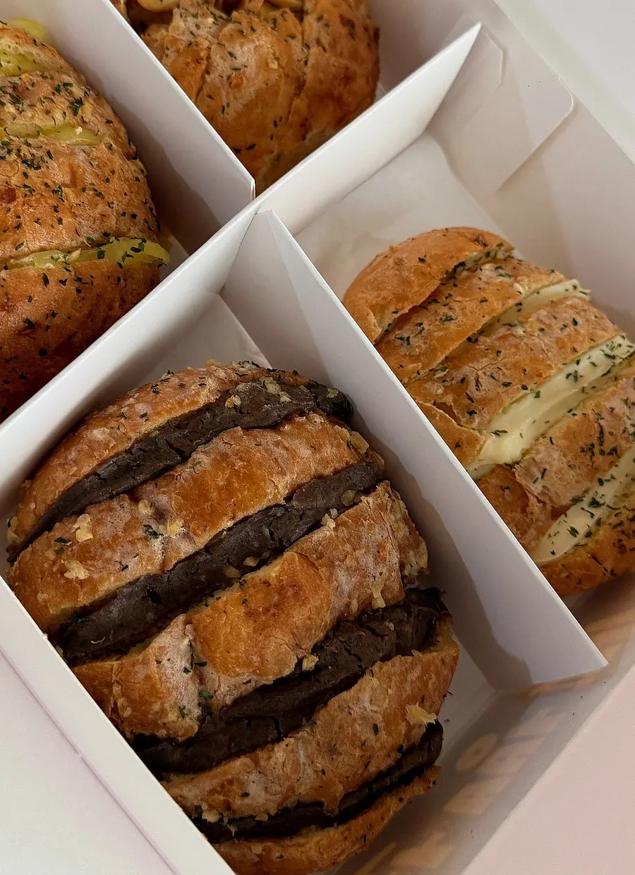 Holding a packed box of Danyang garlic bread