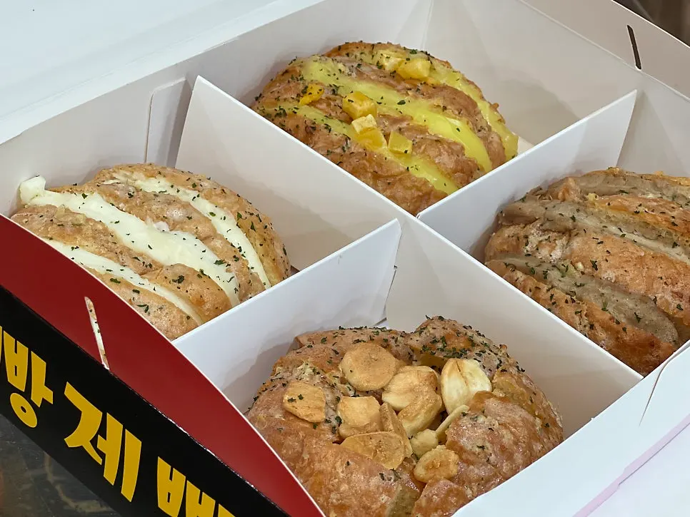 Two packed boxes of garlic bread