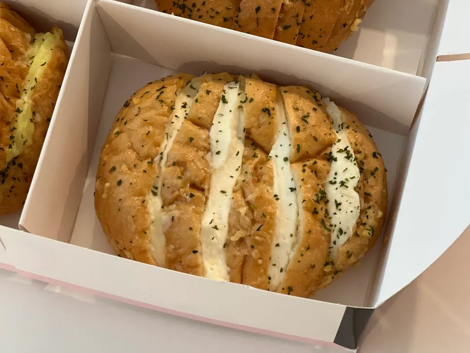 Cross-section of garlic bread packed with cream