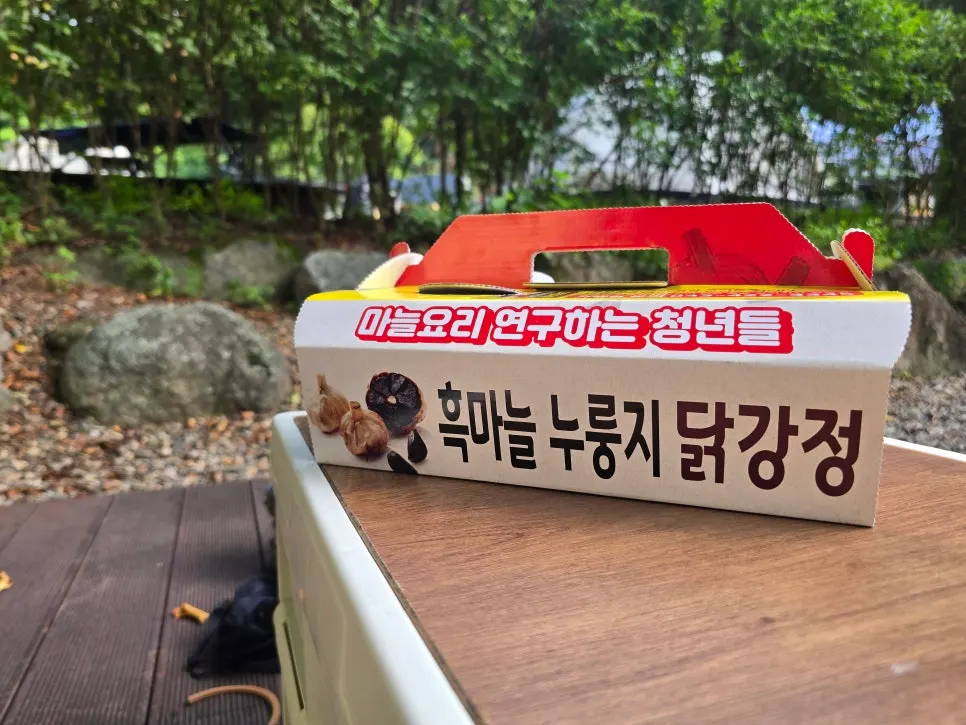 캠핑장 숲 배경의 닭강정 저녁 상차림