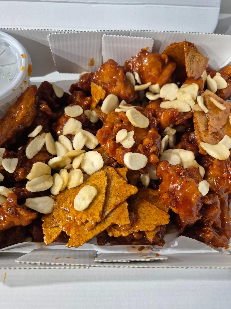 Black garlic nurungji dakgangjeong topped with garlic chips and nurungji