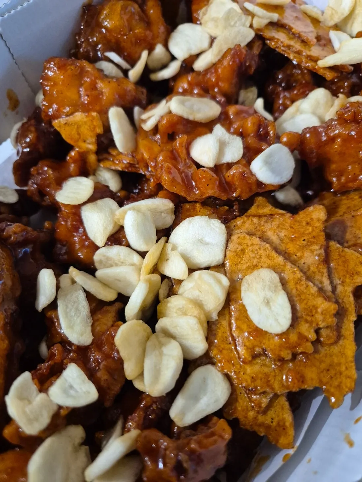A box of Danyang dakgangjeong loaded with nurungji topping