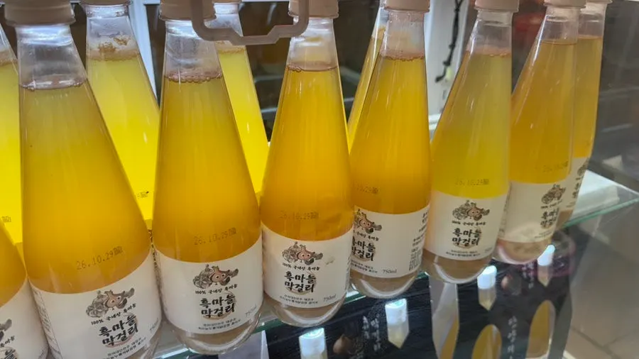 Bottles of black garlic makgeolli on display