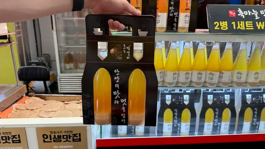 A two-bottle set of black garlic makgeolli packed with a carry handle