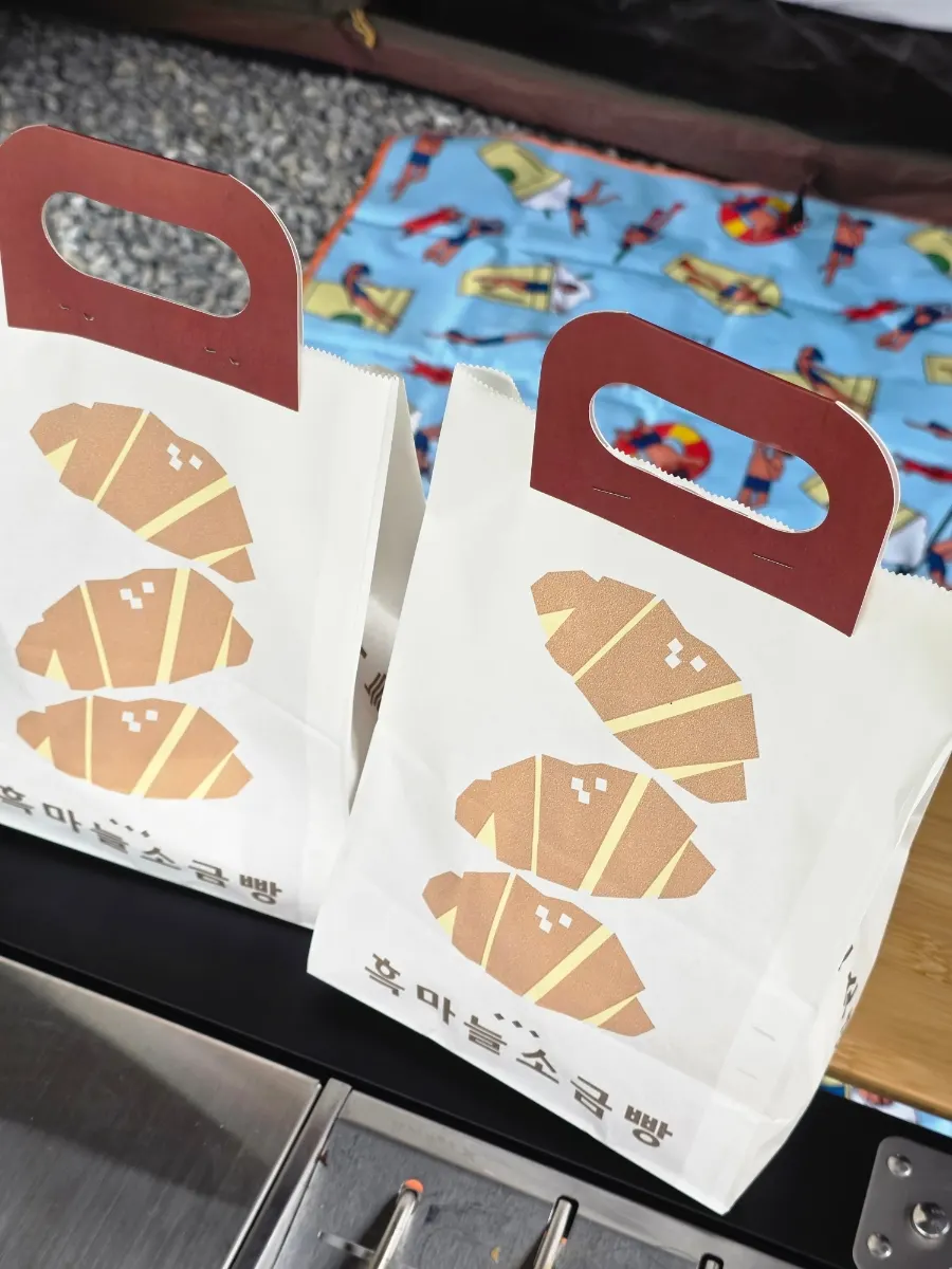 Two purchased salt bread sets with the shop in the background
