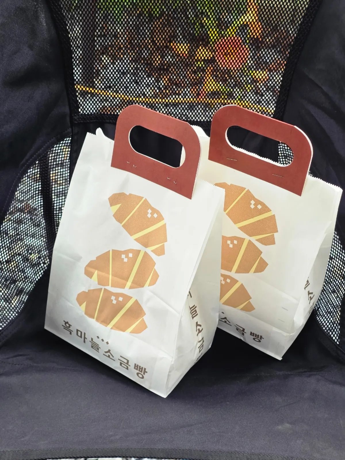 Bag of Black Garlic Salt Bread set on a campsite table