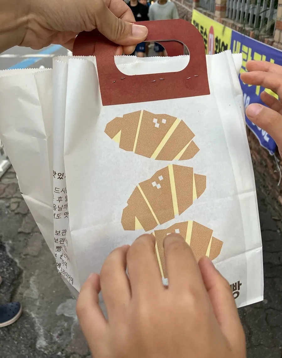 Black Garlic Salt Bread paper bag with an attached handle