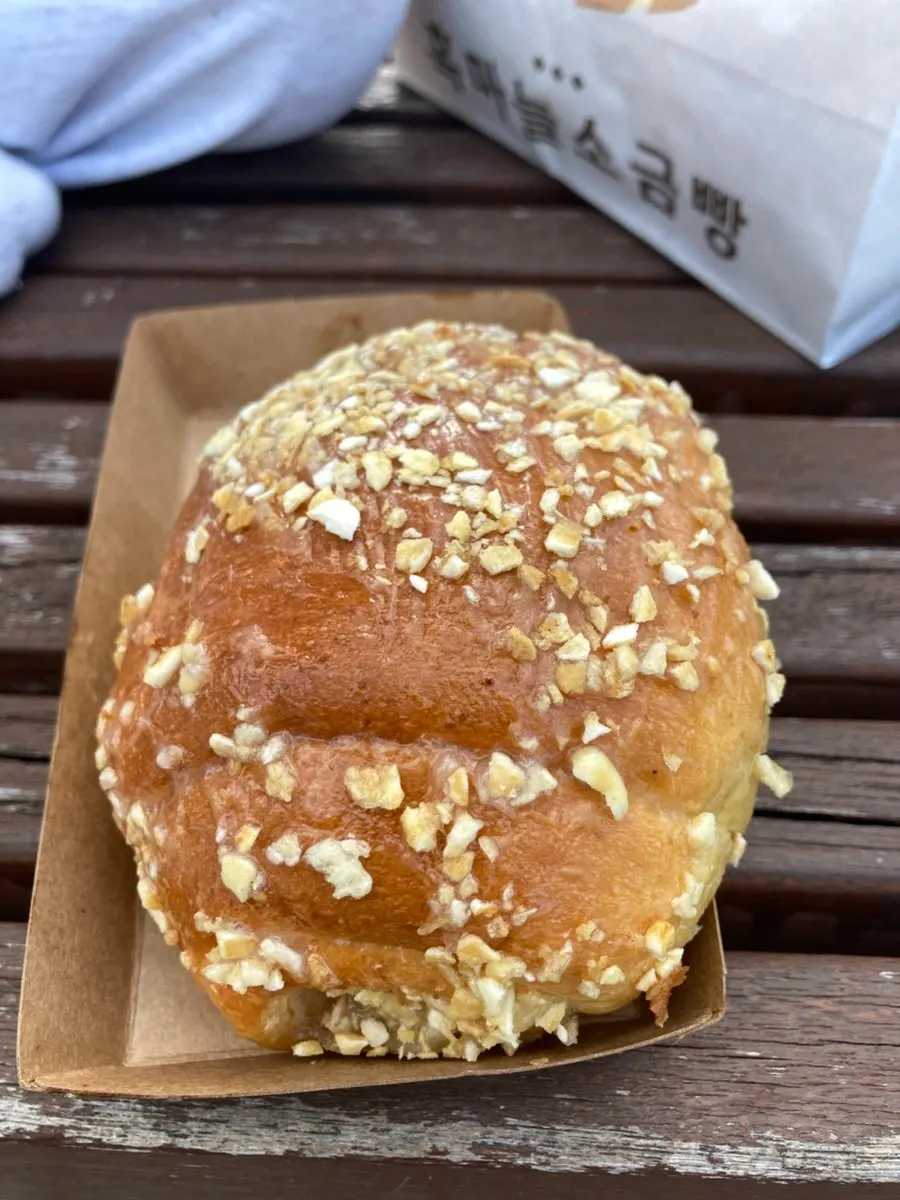 Salt bread set unpacked on a riverside bench in front of the market