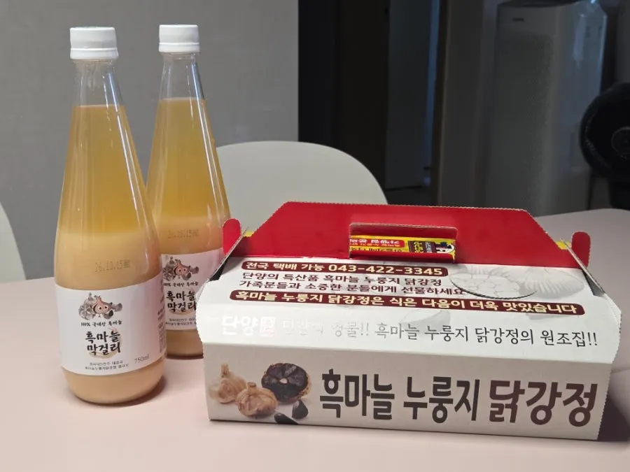Two bottles of packaged black garlic makgeolli