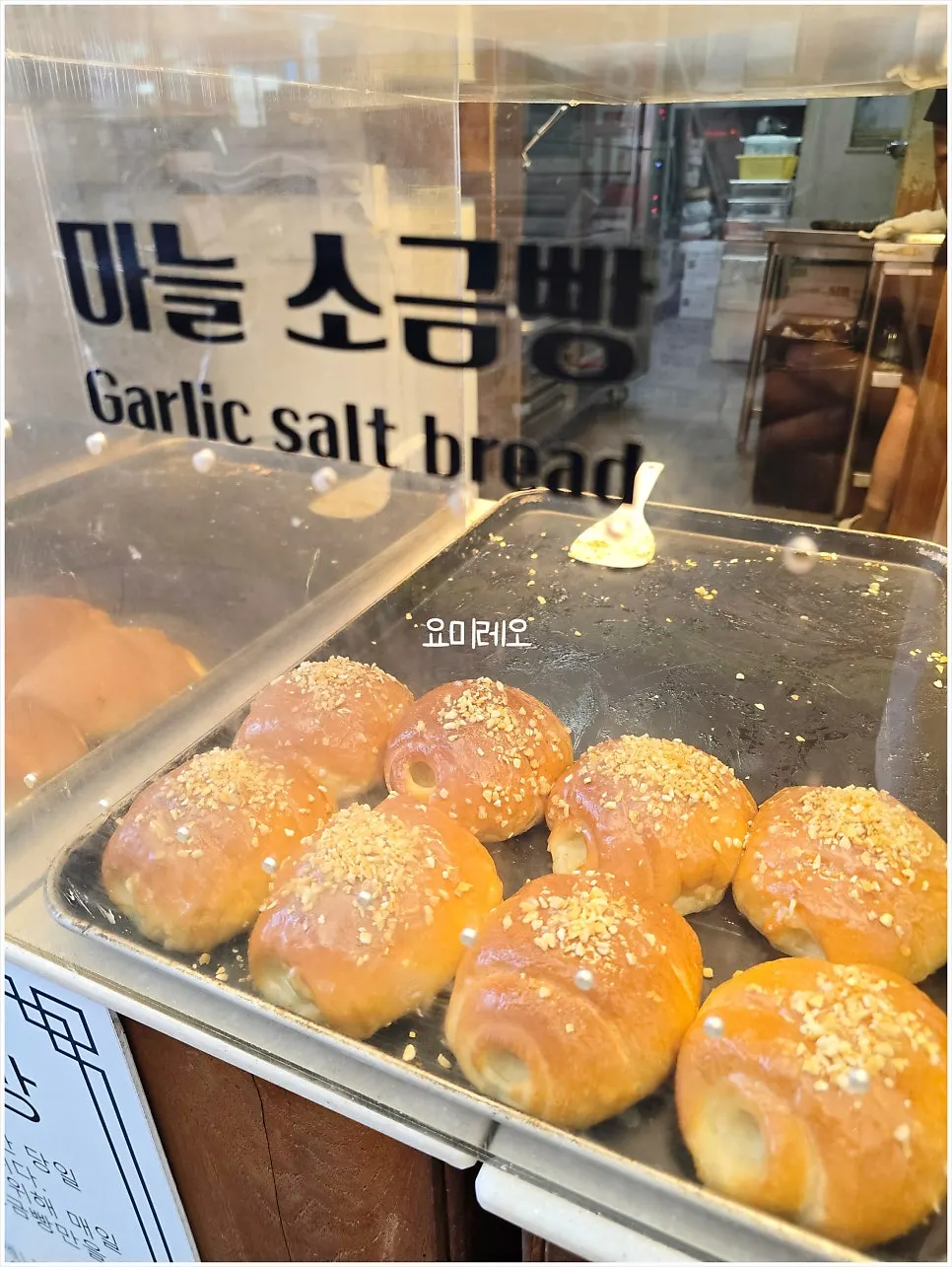 Menu sign featuring a black garlic character