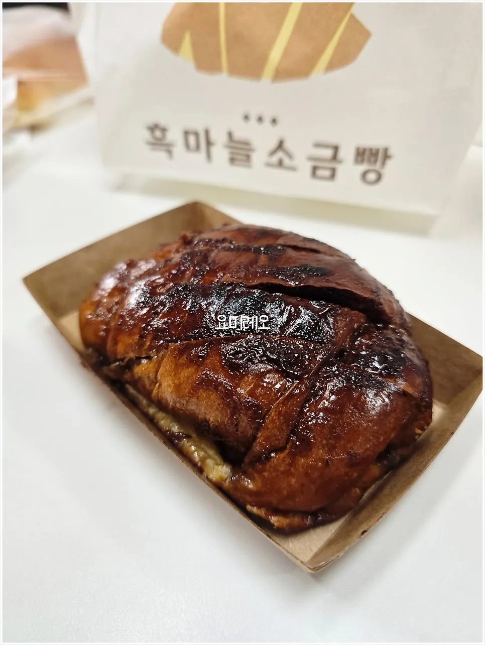 Dark brown salt bread coated with black garlic extract sauce
