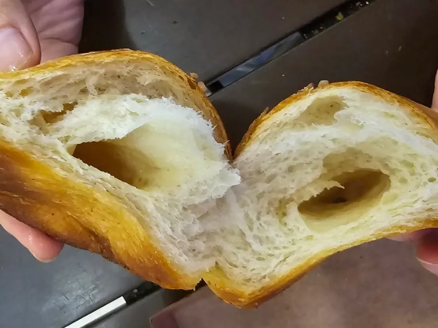 Large original salt bread held in a child's hand