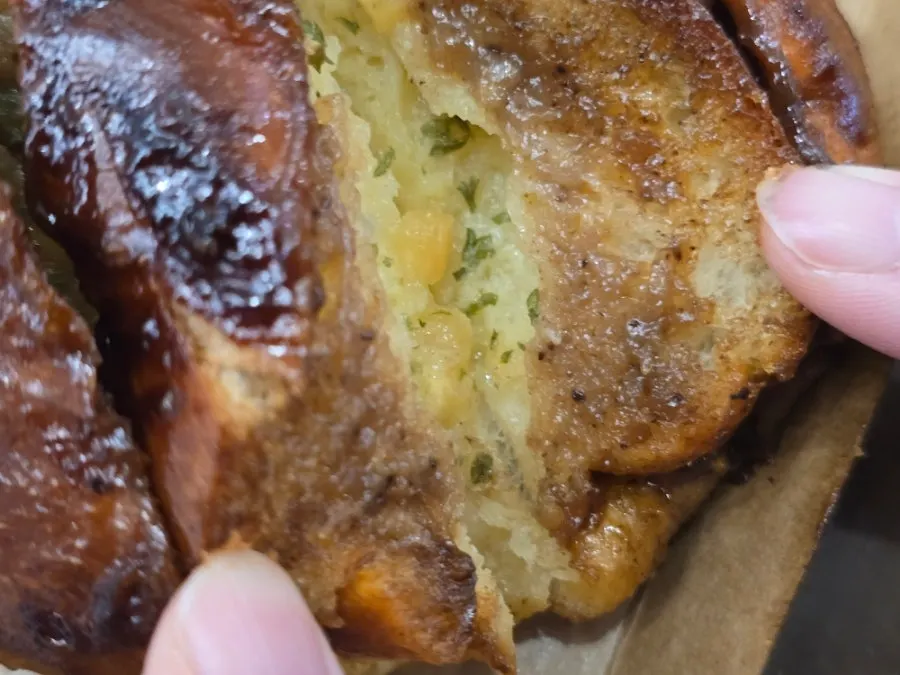 Holding the garlic salt bread