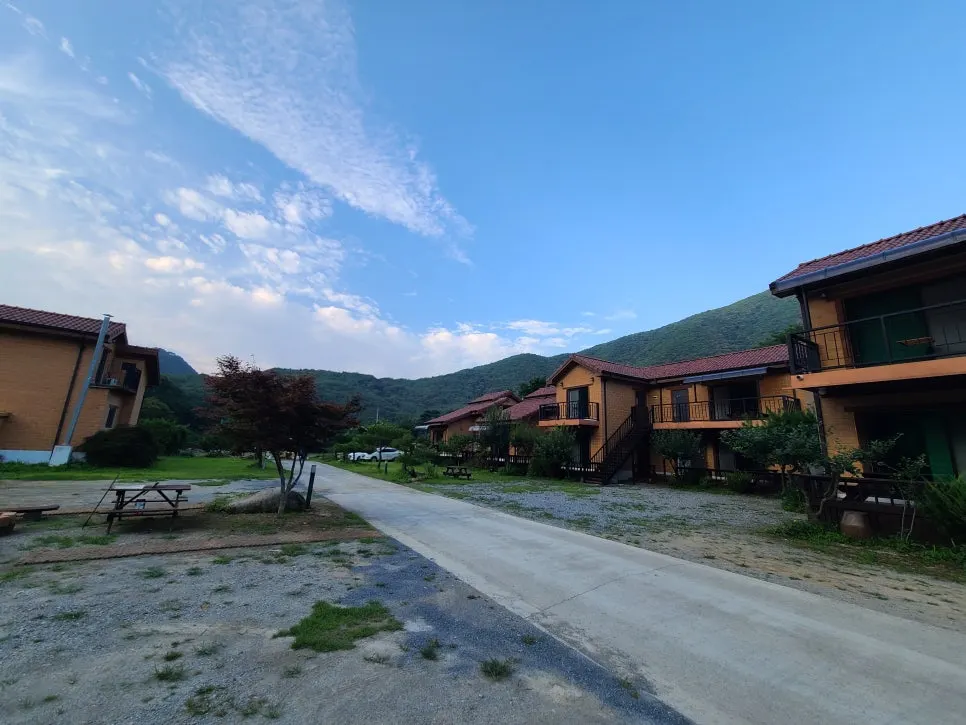 View of the guesthouse with dense forest and mountains in the background