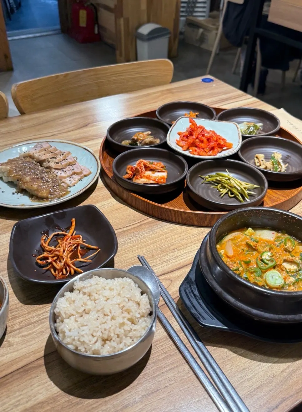 Full spread with boiled pork, garlic rice, and stew