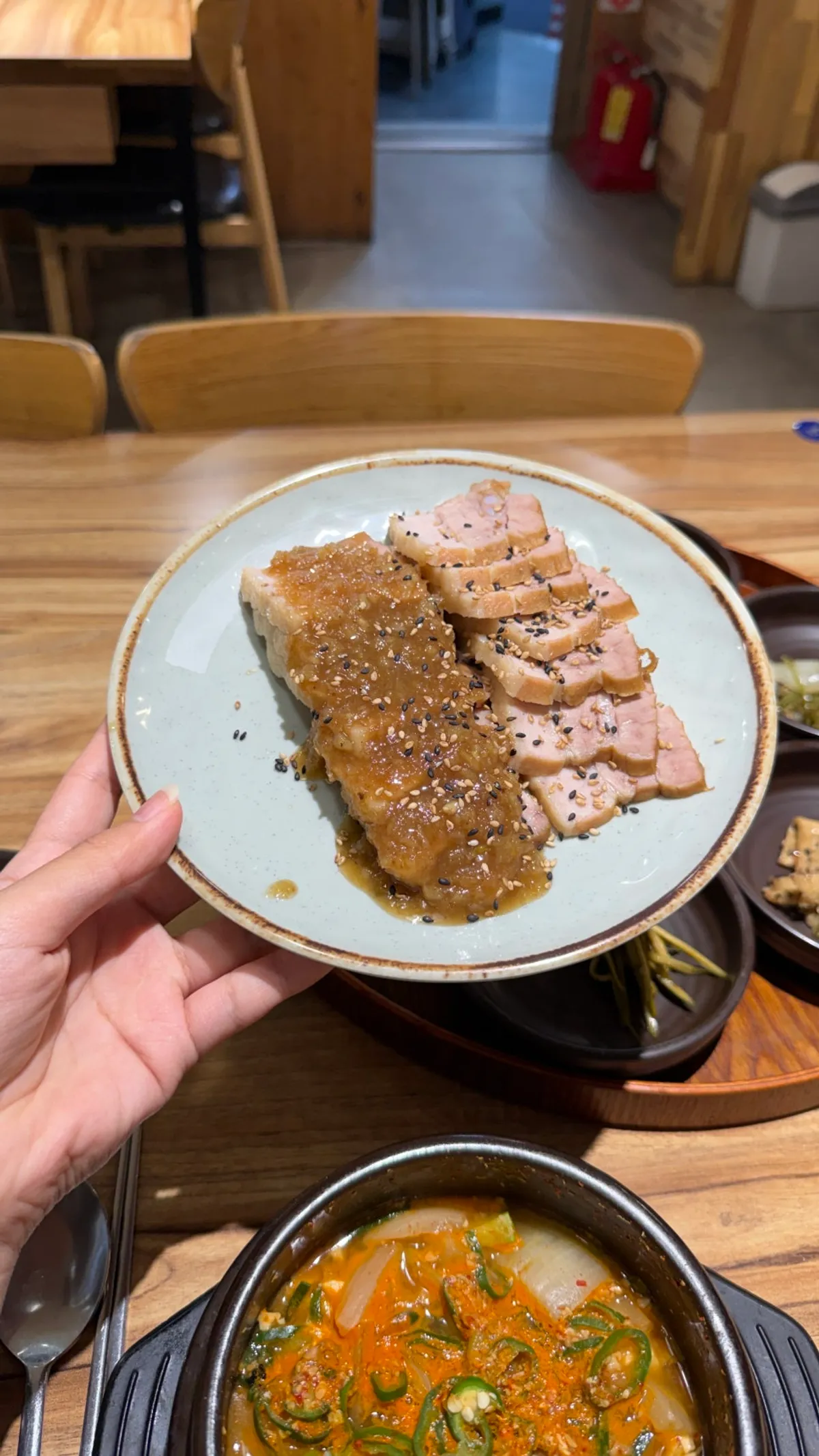Plate of boiled pork topped with black garlic sauce