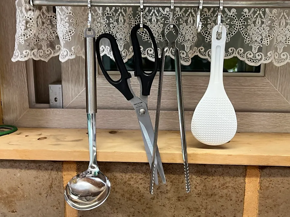 Kitchen prepared with utensils and cookware