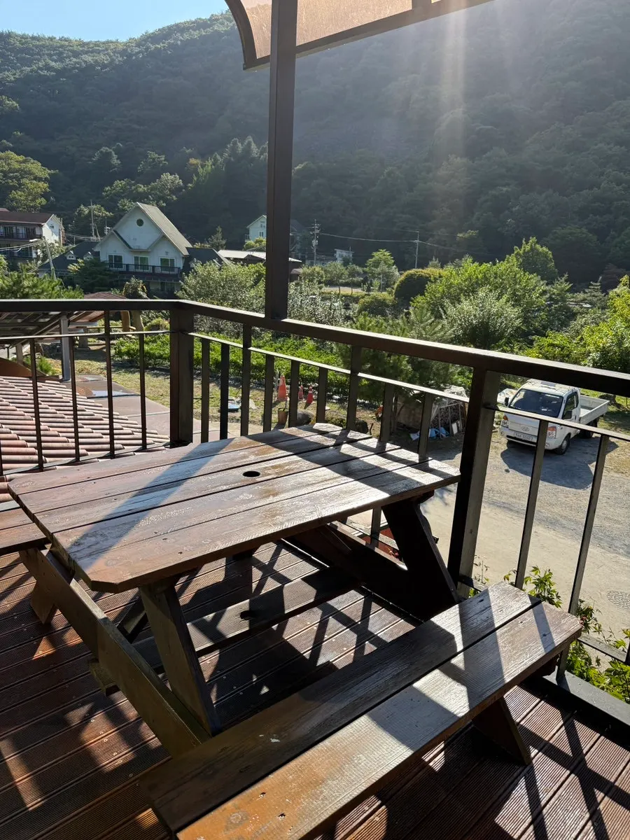 Charcoal and grill ready on the veranda for barbecue