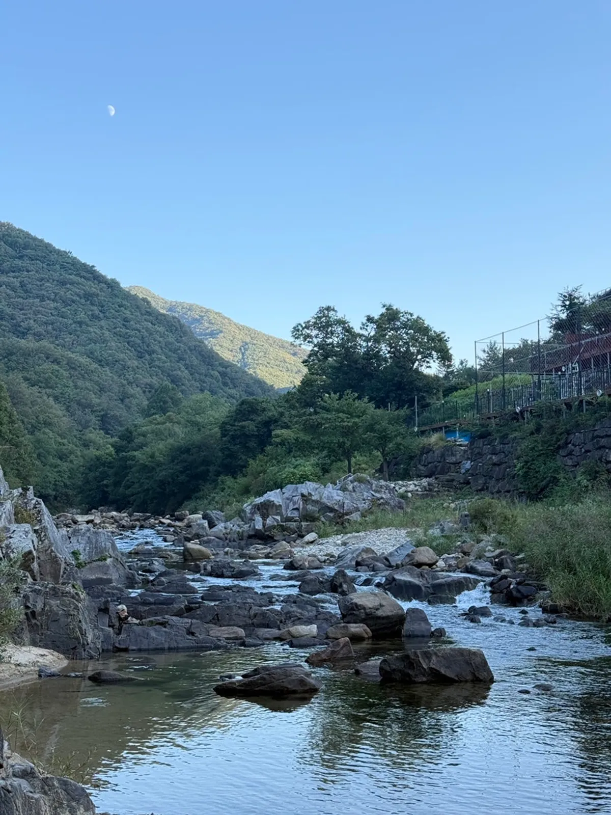 Clear stream flowing through the valley near the pension