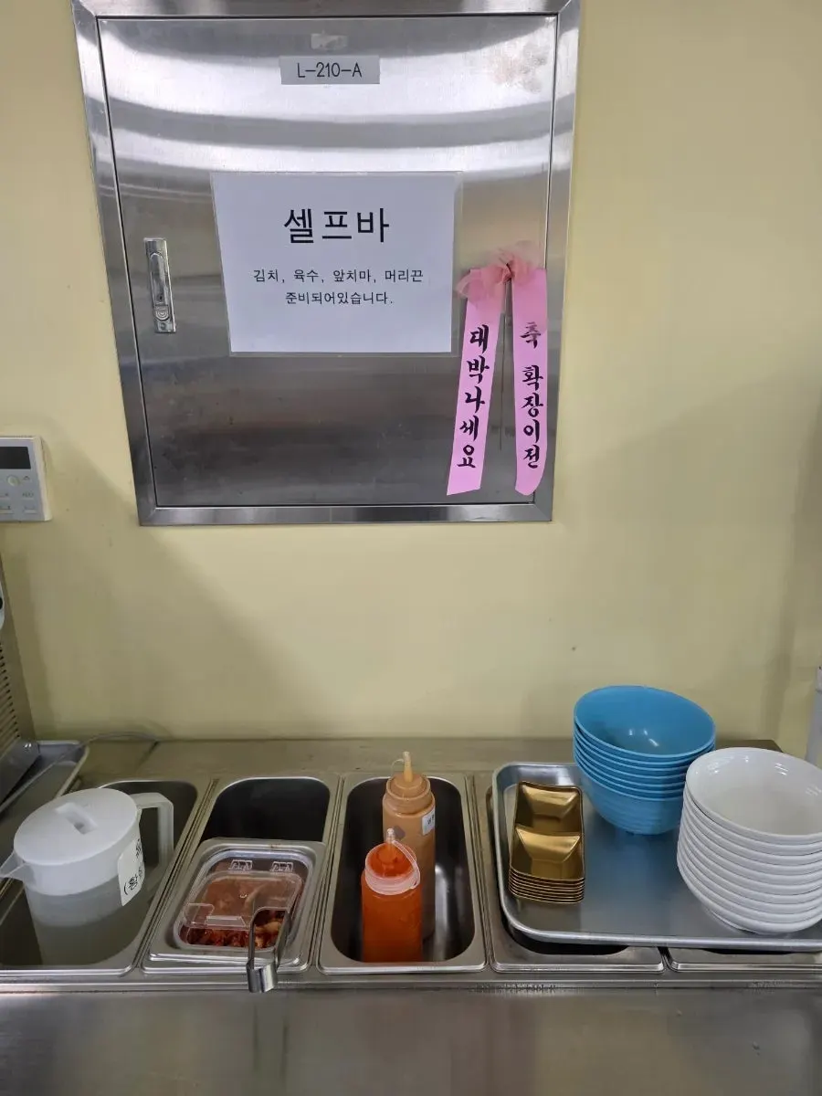 Shabu-shabu table setting with clear, spicy, doenjang, and perilla broth options