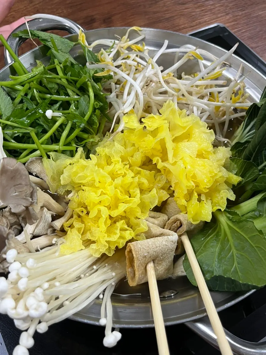 Assorted vegetable platter with mushrooms, bean sprouts, and water dropwort for shabu-shabu