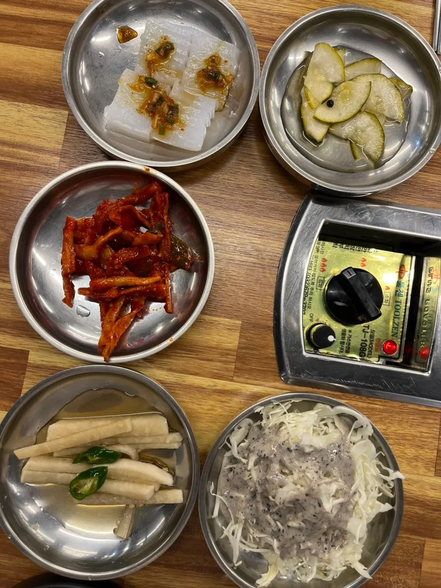 Full spread of side dishes at Dwaegal Gongmyeong Soba