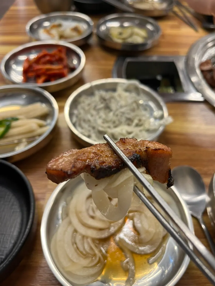 A piece of pork ribs topped with pickled onion