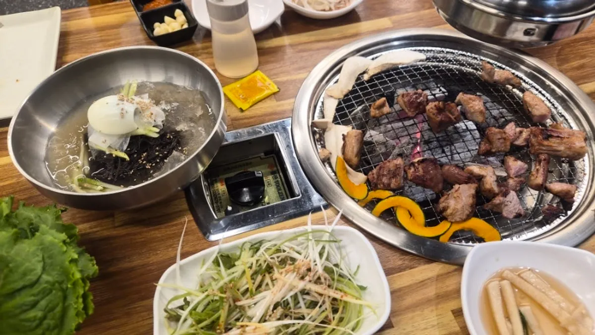 Table setup at Dwaegal Gongmyeong Soba near Dapsimni Station with marinated pork ribs