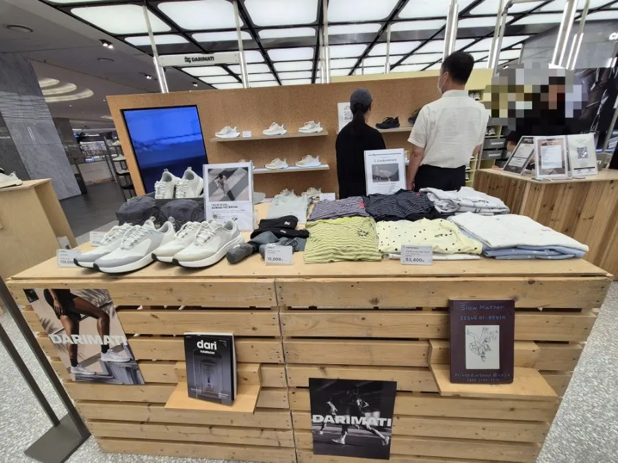 Sofa in the middle of the pop-up store and shoe display shelves