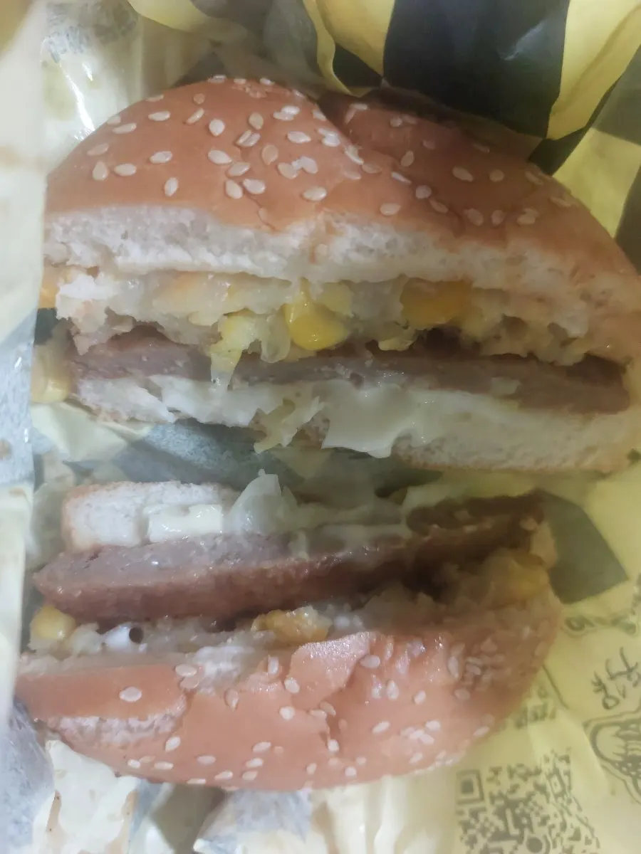 Three packed burgers: egg, corn, and cheese