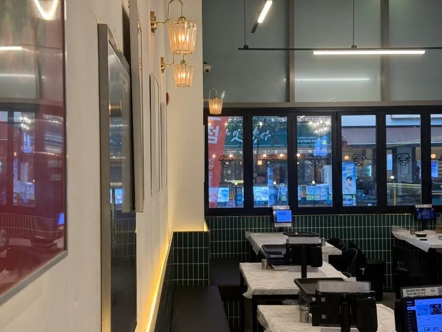 View of the restaurant with full glass windows and wood-tone decor