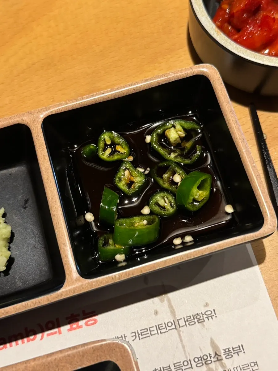 Four side dishes: dried radish, white kimchi, pepper, and mustard leaf kimchi