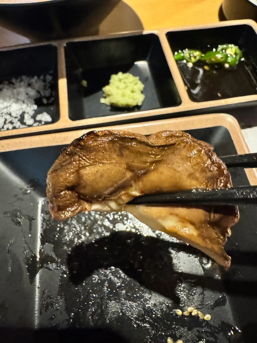 Green onions served alongside grilled lamb