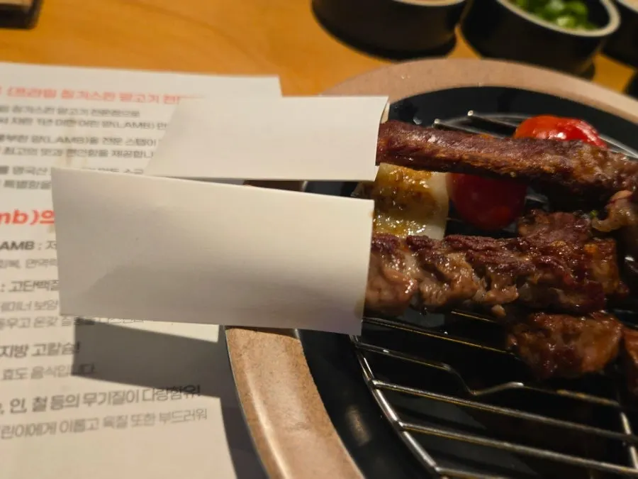 Grilled lamb bones wrapped in paper