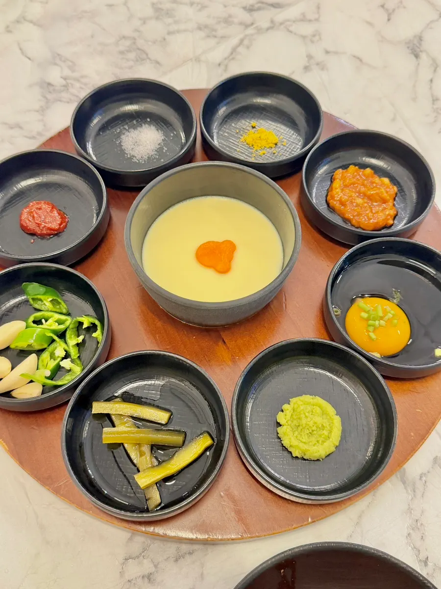 Basic side dishes and pudding-like steamed egg on a wooden tray