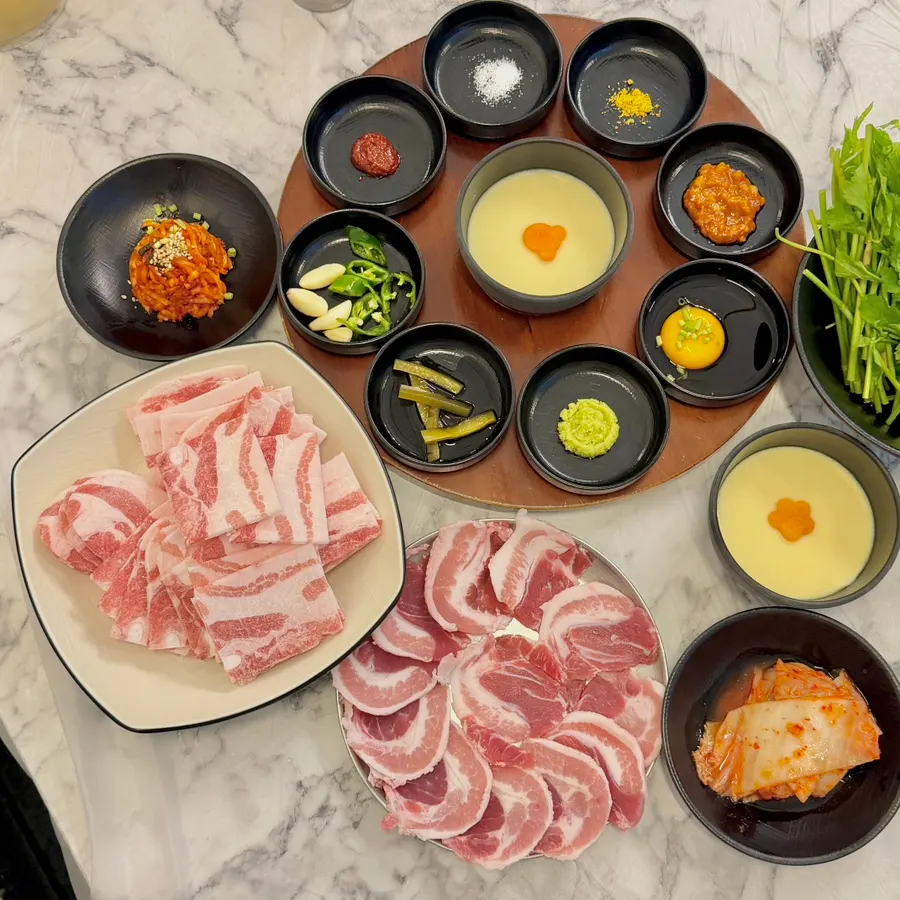 Accompaniments including pickles, garlic, and fresh wasabi