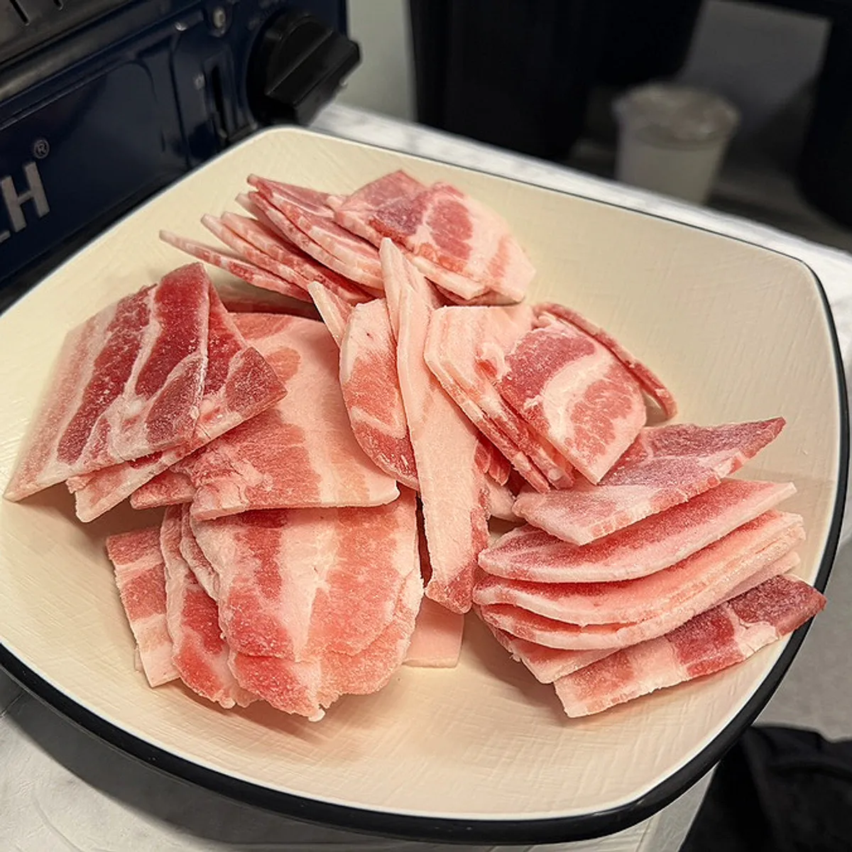 Main table spread of frozen pork belly at Eungbongjip Dasan Station Branch
