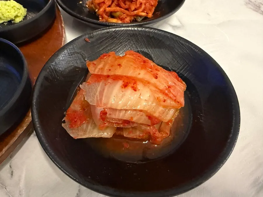 Small bowls of sauces and sides for the meat