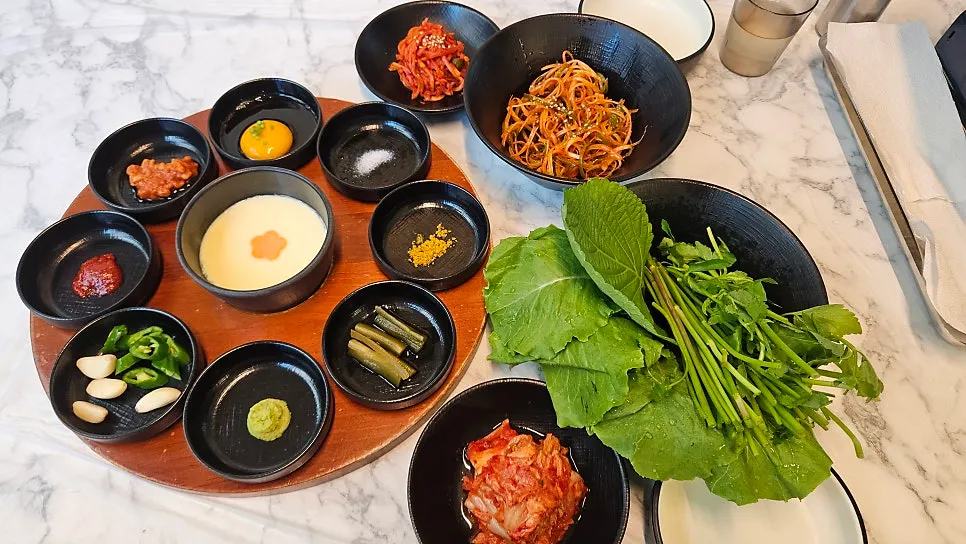 Table of standard side dishes with lettuce wraps and sauces
