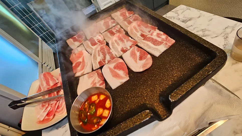 Flash-frozen samgyeopsal on the grill