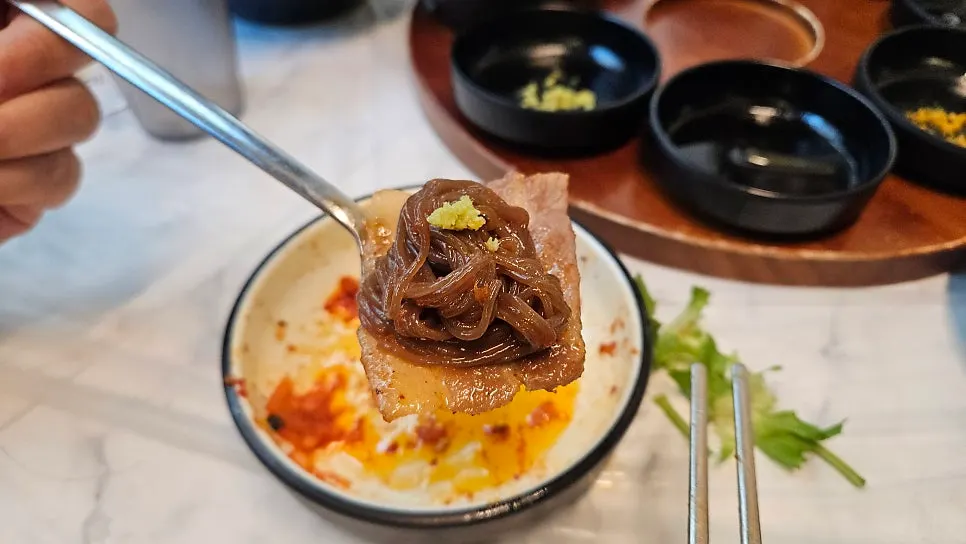Meat and naengmyeon combo topped with wasabi