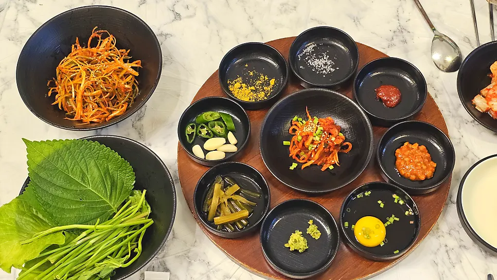 Table set with more than eight side dishes and wrap vegetables