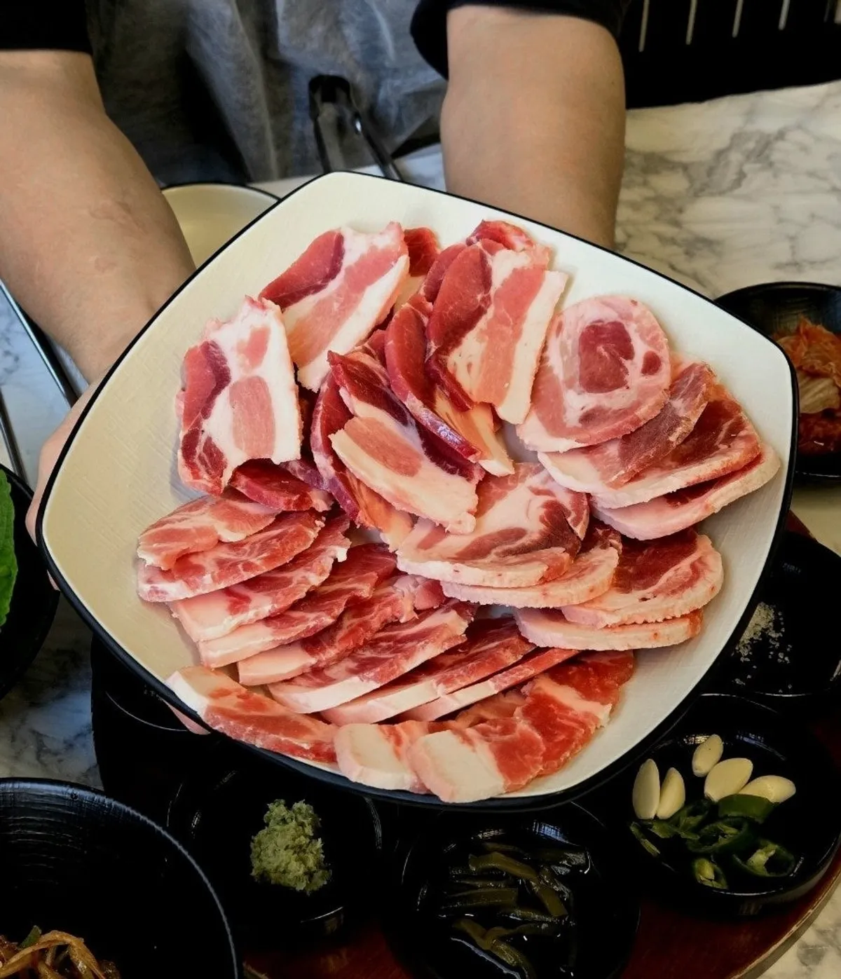Three pork specialty cuts served on a large plate