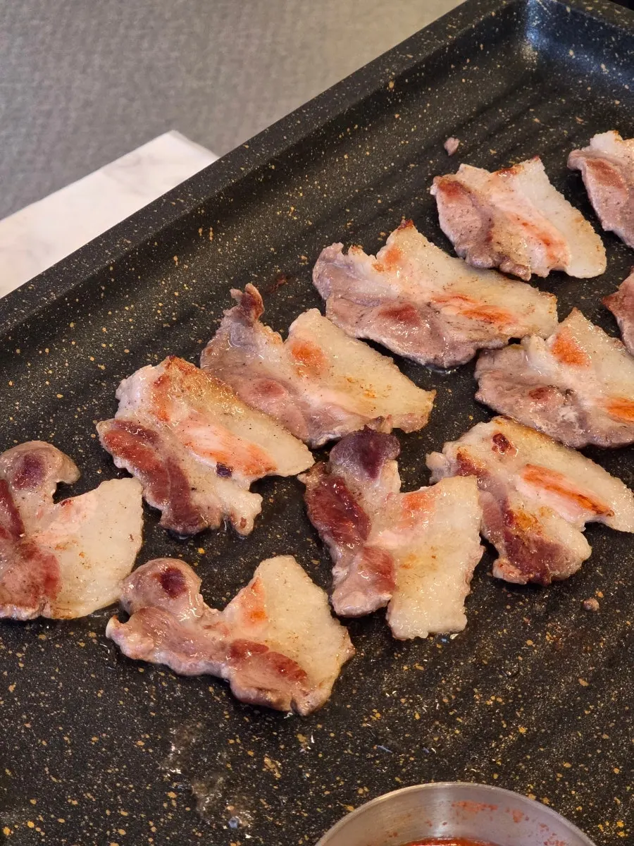 Specialty pork cuts placed on the grill