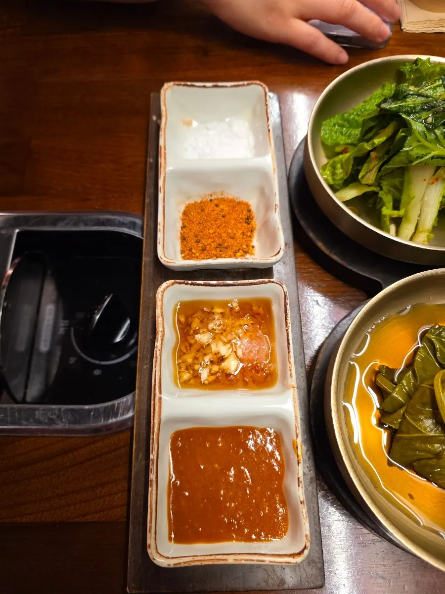 Four sauces: salt, lamb skewer seasoning, garlic sesame oil sauce, ssamjang